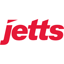 The image showcases the logos of Jetts Fitness, featuring two distinct designs, one with "vee" in red and white, and the other representing the TSS organization. The brand name "jetts" is written below the logos in bold lettering.