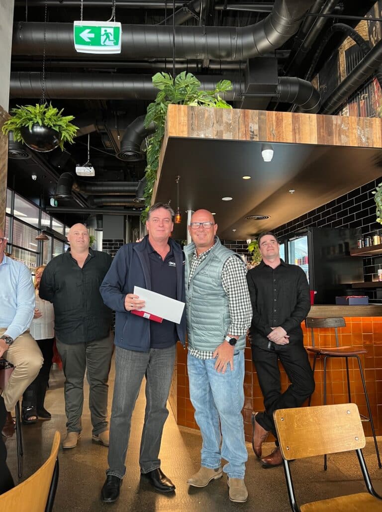 Vibrant Celebration at SCS Group: Managing Director Nick Pastras and Friends Enjoying a Lively Restaurant Gathering