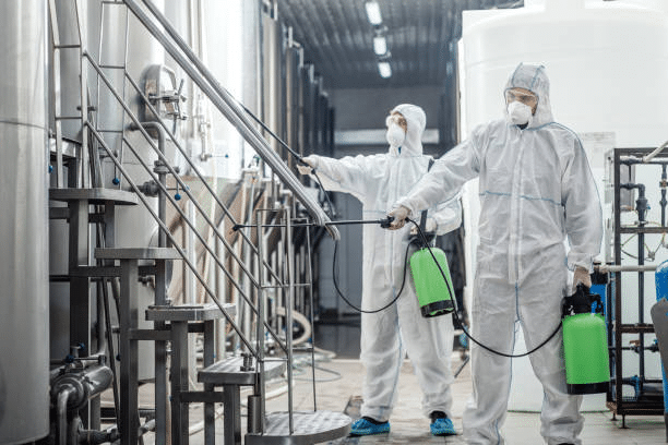 Industrial Cleaners Ensuring Factory Hygiene - Expertly Spraying for a Safe and Efficient Environment"