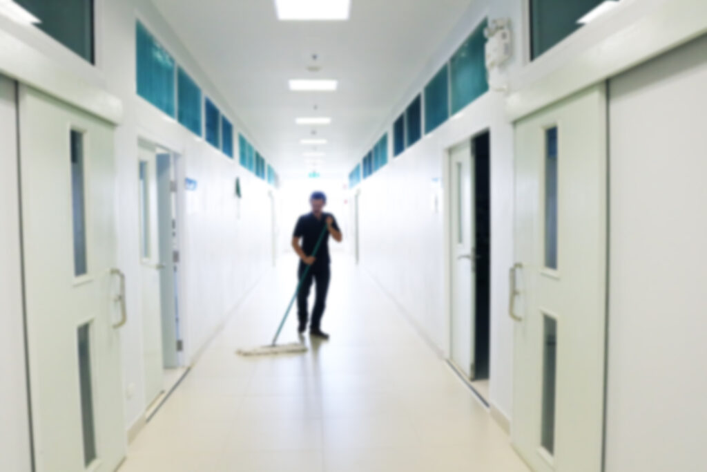 Janitor,Man,Mopping,Floor,In,Hallway,New,Office,Building,Or